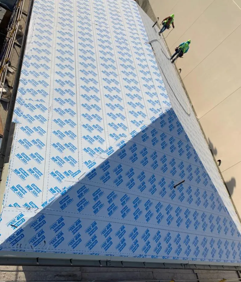 Professional roofers installing underlayment on a metal roof in San Ramon